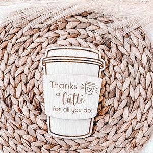 May include: A wooden coffee cup sleeve with the text "Thanks a latte for all you do!" and a small coffee cup icon with a heart.