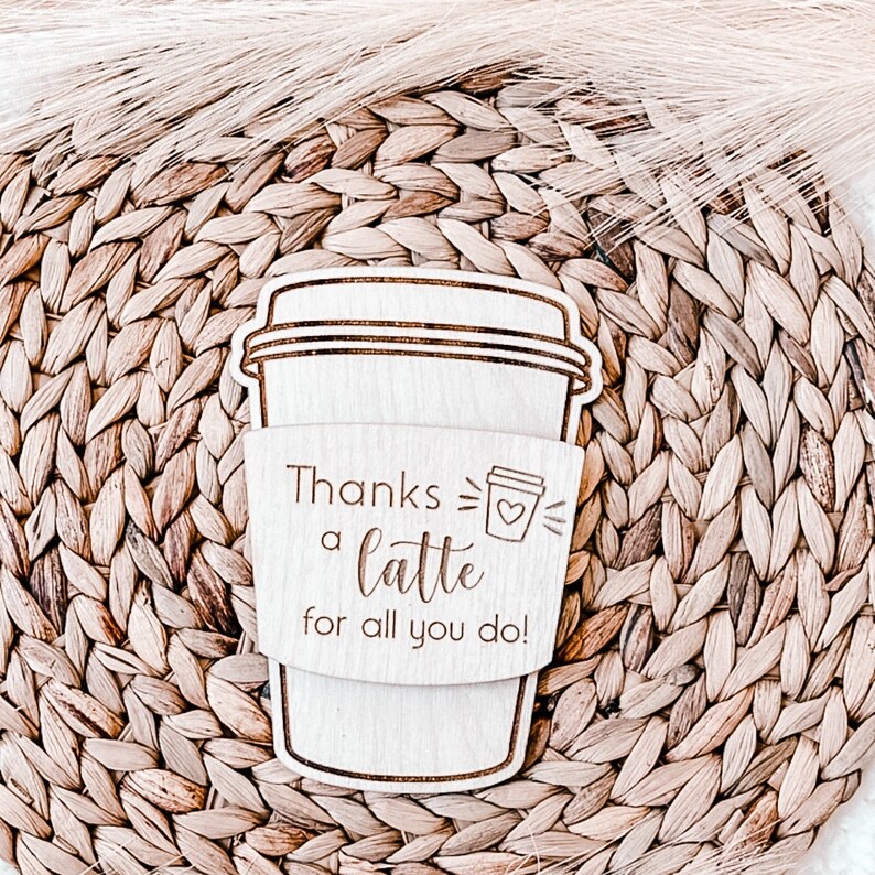 May include: A wooden coffee cup sleeve with the text "Thanks a latte for all you do!" and a small coffee cup icon with a heart.