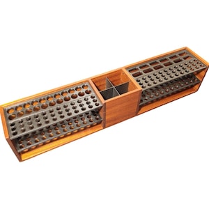 May include: A wooden organizer with multiple compartments and metal inserts. The organizer has a rectangular shape with a natural wood finish. The metal inserts feature various sized holes, likely for holding tools or small items. The design is functional and organized.