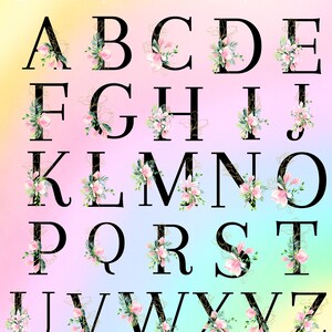 May include: Floral monogram alphabet with pink flowers and gold accents on a rainbow background. The letters are black and outlined in gold.