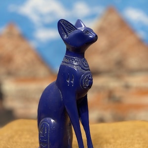 Egyptian Bastet cat statue, with a pharaonic necklace on the neck. Egyptian cat statue.