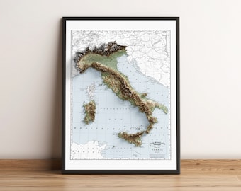 May include: A vintage-style, 3D relief map of Italy, printed in black and white with brown and green accents. The map is framed in black and is displayed on a wooden surface.