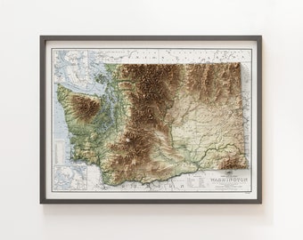 May include: A framed vintage-style relief map of the state of Washington, showing the topography of the state with mountains, valleys, and rivers. The map is in shades of green, brown, and blue, and includes the text "Relief Map of WASHINGTON".