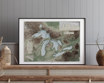 May include: A framed map of the Great Lakes region with a detailed topographic view of the lakes and surrounding land. The map is in a black frame and has a white mat. The map is printed on a cream-colored paper with brown and green colors.