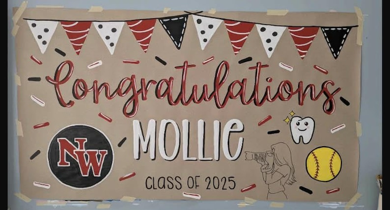 May include: A handmade banner with the words "Congratulations Mollie Class of 2025" in red and white lettering. The banner includes a school logo, a tooth, a softball, and decorative pennants.