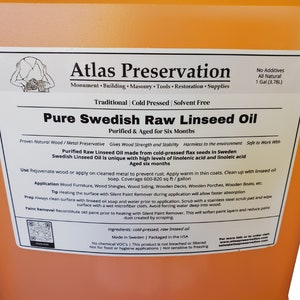 May include: A gallon jug of Atlas Preservation Pure Swedish Raw Linseed Oil. The label is orange and white and says "Traditional Cold Pressed Solvent Free" and "Purified & Aged for Six Months". It is made from cold-pressed flax seeds in Sweden and is all natural. The label also says "No Additives" and "1 Gal (3.78L)".