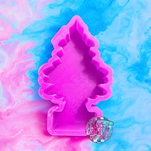May include: A bright pink, Christmas tree-shaped cookie cutter. The cutter is made of plastic and has a detailed outline of a fir tree. The background is a swirl of pink and blue colors. The image includes a logo that says "Hearts-N-Crafts Designs".