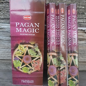May include: A collection of incense sticks in burgundy packaging. The boxes feature the text "PAGAN MAGIC" and "INCENSE STICKS". The packaging includes a pentagram design with leaves and berries. The brand name "HEM" is visible on the boxes.