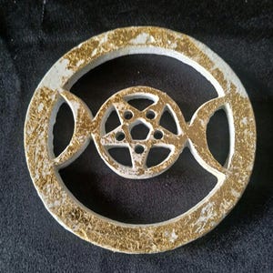May include: White wooden incense burner with a gold finish. The burner features a triple moon and pentagram design.