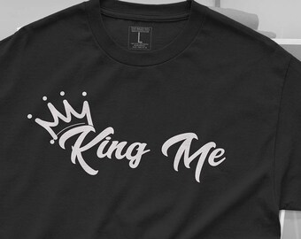 May include: Black t-shirt with a white crown and the text "King Me" in a stylized font.