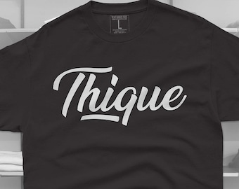 May include: Black t-shirt with a white graphic that says "Thique" in a stylized font.