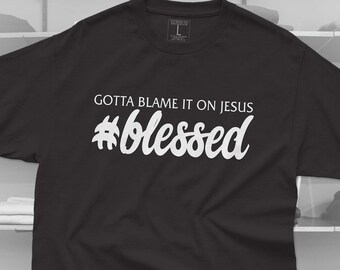 May include: Black t-shirt with white text that reads "Gotta Blame It On Jesus #blessed".
