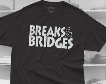 May include: Black t-shirt with white text that reads "Breaks & Bridges".