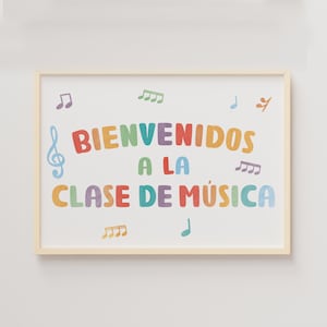 May include: A framed print with the words "BIENVENIDOS A LA CLASE DE MÚSICA" in colourful letters. Musical notes and a treble clef decorate the white background. The frame is a light wood colour.