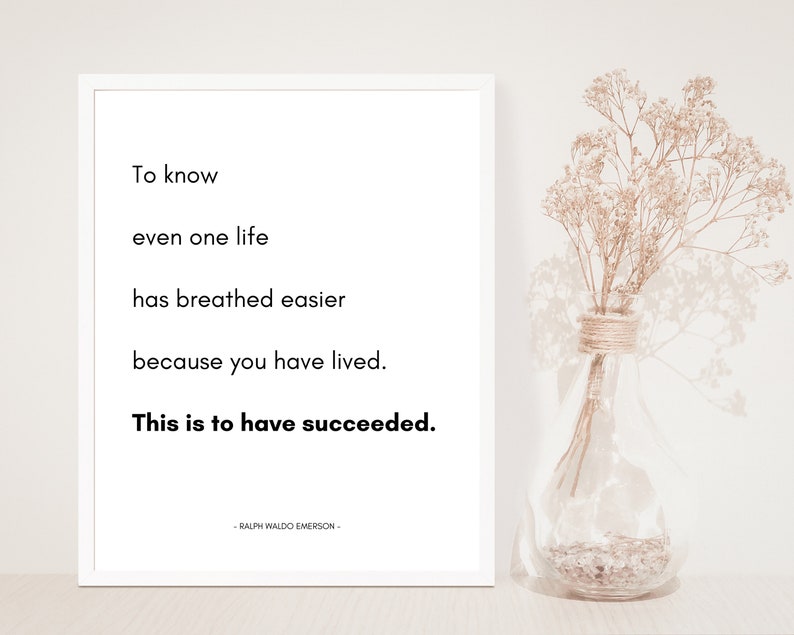 May include: A white framed print with a black and white quote by Ralph Waldo Emerson. The quote reads: "To know even one life has breathed easier because you have lived. This is to have succeeded."
