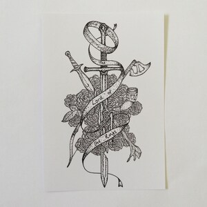 May include: A black and white illustration of a sword, a ring, an axe, and a goblet surrounded by roses. The text "The Lord of the Rings" is written on a ribbon.