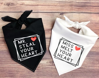 May include: Two black and white fabric bandanas with red hearts and text. The black bandana says "Mr. Steal Your Heart" and the white bandana says "Miss Melt Your Heart".