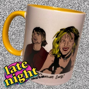 May include: White ceramic mug with a yellow rim and handle. The mug features a cartoon illustration of two people with the text "late night novelties Courtney Love" at the bottom.
