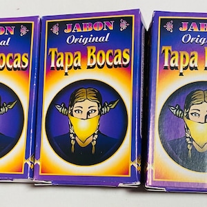 Puede incluir: Tres cajas moradas y amarillas con el texto "Jabon Original Tapa Bocas" y una imagen de dibujos animados de una persona con una máscara facial amarilla.