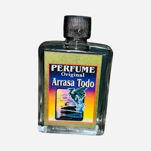 May include: A small, clear glass bottle with a black cap. The label reads "PERFUME Original Arrasa Todo" and features a colorful image of a dragon.