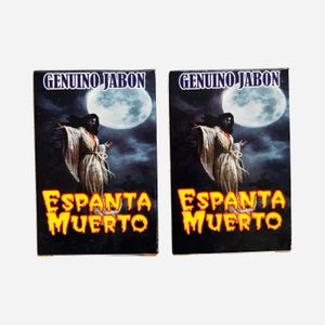 May include: Two rectangular soap boxes featuring the text Genuino Jabon and Espanta Muerto. The design displays a figure in a white robe standing under a large full moon against a dark, cloudy night sky with a spooky, atmospheric aesthetic.