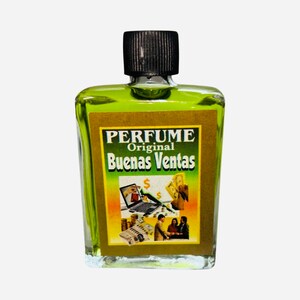 May include: A small, clear glass bottle with a black cap filled with a green liquid. The bottle has a gold label with the text "PERFUME Original Buenas Ventas" and an image of a laptop computer, money, and people.