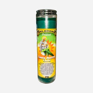 May include: A tall, cylindrical glass candle with a green top and a label featuring an illustration of a saint and chili peppers. The label also includes the text "VELADORA Original Santa Muerte Chile".