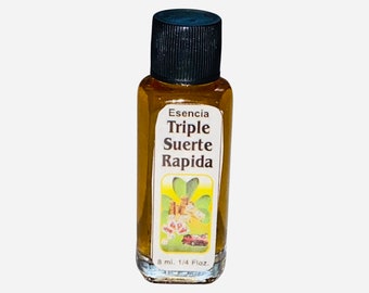 May include: A small, clear glass bottle with a black cap filled with a golden liquid. The label reads "Esencia Triple Suerte Rapida" and features a green four-leaf clover with a car, money, and other symbols. The bottle contains 8 ml or 1/4 fl oz.