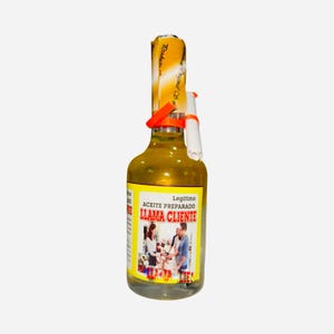 May include: A clear glass bottle filled with yellow liquid, sealed with a yellow and orange label and a red ribbon. The label reads "Legitimo Aceite Preparado Llama Cliente" with an image of people interacting.