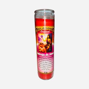 May include: A red glass candle with a label featuring the text "VELADORA Original" and "Embrujo de Amor". The label depicts a woman and a couple. The candle is filled with red wax.
