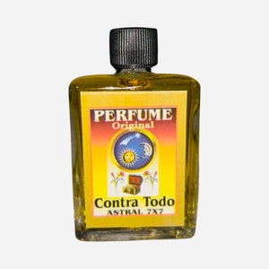 May include: A small, clear glass bottle with a black cap filled with a yellow liquid. The label is yellow with black text that reads "PERFUME Original" and a blue and yellow image of a sun, moon, and star. Below the image is the text "Contra Todo ASTRAL 7X7".