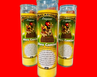 May include: Three yellow candles with a red heart and a staircase with money on it. The candles are labeled "Veladora Original" and "Abre Camino". The text on the candles reads "Que la sublime influencia del Padre Eterno te ayude a tener exito y adelanto en todos los asuntos de su vida y para allanar todas las dificultades que haya en el camino. La ayuda del espiritu santo para que la estrella alumbre su camino y asi entre para que su siga, invoque a dios y su persona llegue el mensaje de buena suerte."
