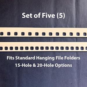 May include: A set of five light-colored, rectangular hanging file folder inserts featuring a series of square cutouts along the bottom edge. The text reads: Set of Five (5), Fits Standard Hanging File Folders, 15-Hole & 20-Hole Options.