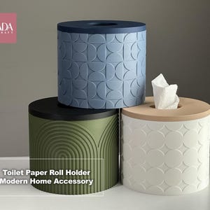 May include: Three modern toilet paper roll holders in blue, green, and white. The blue holder has a geometric pattern, the green has an arched design, and the white has a circular pattern. One holder has tissue paper.