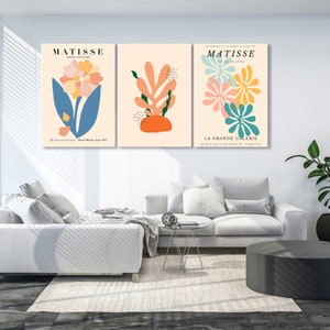 May include: Three abstract art prints featuring colorful floral and leaf designs. The prints are titled "Matisse" and feature the text "Paper Decoupages" and "La Grande Galerie".