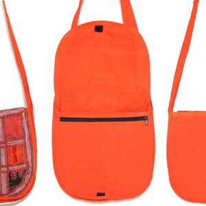 May include: A set of three orange fabric shoulder bags. The first bag has a patchwork design with various colors and patterns. The second bag is open, revealing a black zipper pocket. The third bag is closed. All bags have long, thin straps.