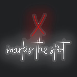May include: A red neon sign with an X and the text "marks the spot" in white neon. The sign is hanging on a black wall above a gray couch.