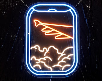 May include: A neon sign with a blue outline and an orange airplane flying over clouds. The sign is hanging from a chain.
