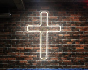 May include: A blue velvet sofa with two red wooden stools in front of it. The sofa has a plaid pillow on the left side and a plaid pillow on the right side. A white neon cross is on the brick wall behind the sofa. The text "EASY NEON" is in yellow neon letters on the bottom right corner of the image.