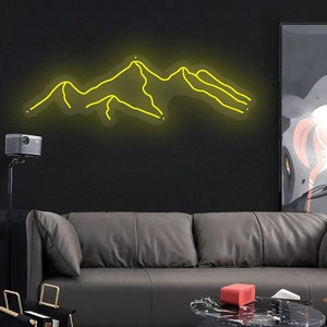 May include: A yellow neon sign depicting a mountain range on a black wall. The sign is mounted above a grey leather sofa and a black coffee table.