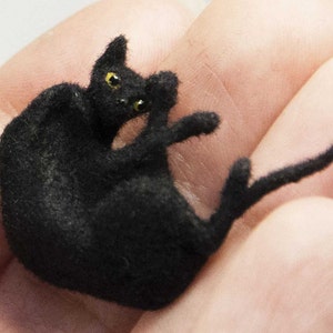 Miniature cat, lying upside down artisan pet in 1:12 twelfth scale for doll house of diorama. Fluffy black kitten toy