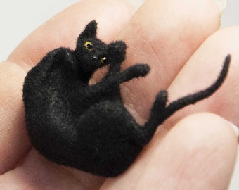 Miniature cat, lying upside down artisan pet in 1:12 twelfth scale for doll house of diorama. Fluffy black kitten toy