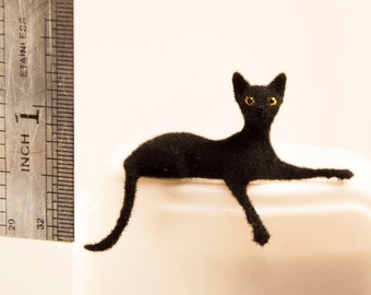 Miniature cat, lying down artisan pet in 1:12 twelfth scale for doll house of diorama. Fluffy black kitten toy
