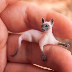 Miniature cat, lying down artisan pet in 1:12 twelfth scale for doll house of diorama. Fluffy siamese kitten toy