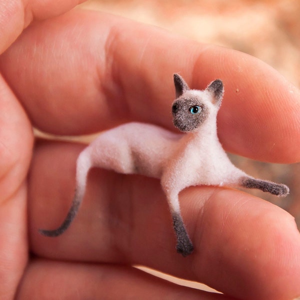 Miniature cat, lying down artisan pet in 1:12 twelfth scale for doll house of diorama. Fluffy siamese kitten toy