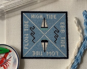 May include: A blue and white needlepoint canvas with the text "High Time To Sail North" and images of a sailboat and seahorses.