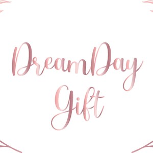 May include: A rose gold logo with a wreath of leaves on either side. The logo reads "Dream Day Gift".