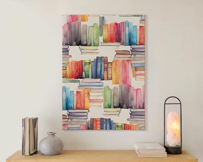 May include: Watercolor painting of a bookshelf with stacks of books in various colors. The artwork features a vibrant palette of blues, reds, greens, and yellows. The painting is displayed on a white wall above a wooden surface.