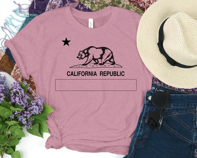 May include: A pink t-shirt with a black graphic of the California bear and the text "CALIFORNIA REPUBLIC".