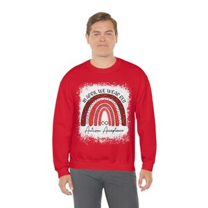 May include: Red sweatshirt with a rainbow design and the text "In April We Wear Red Autism Acceptance".